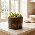 Antique oak bucket styled with fresh Antique oak bucket styled with fresh green pears in a bright French country kitchen