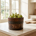 Antique oak bucket styled with fresh Antique oak bucket styled with fresh green pears in a bright French country kitchen