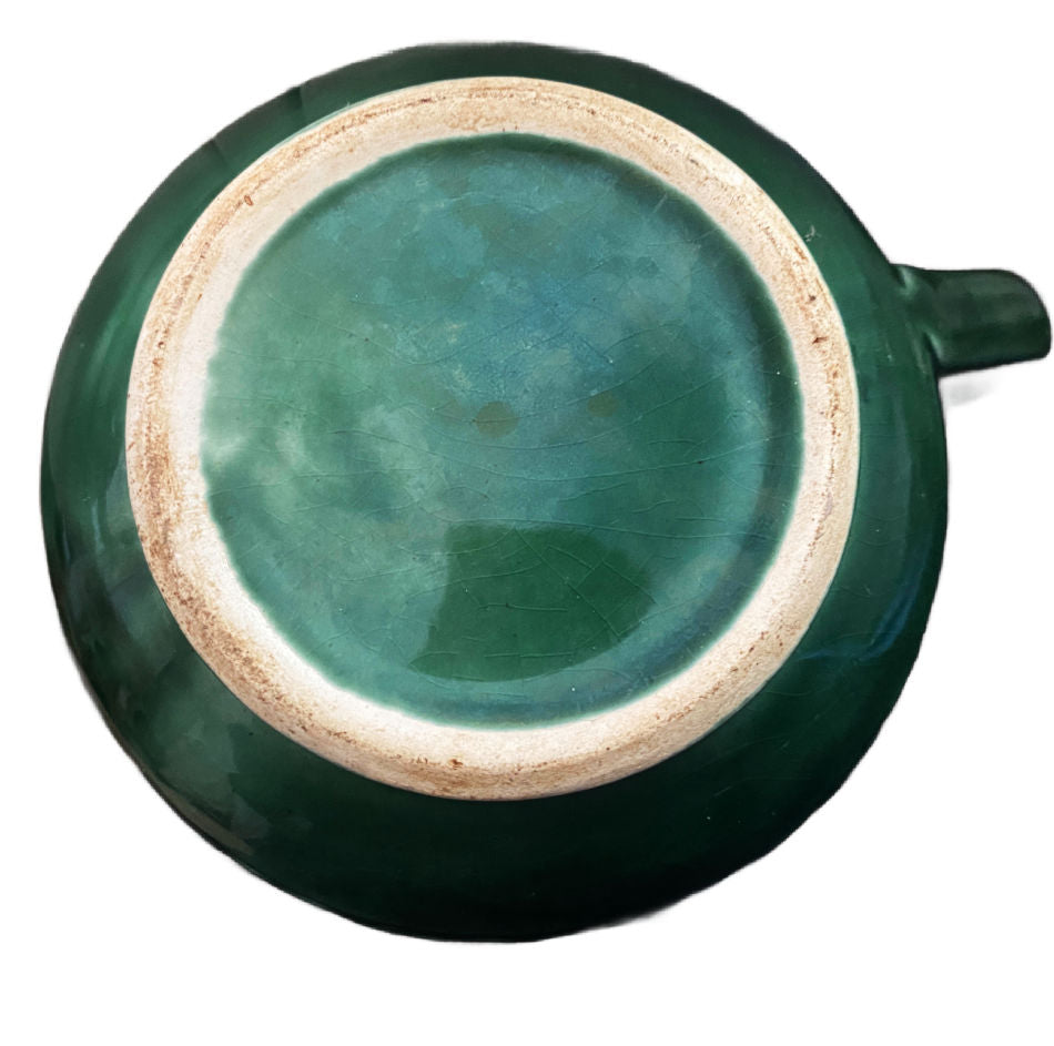 Detail of molded basketweave and green glaze on antique French majolica pitcher bottom