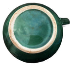 Detail of molded basketweave and green glaze on antique French majolica pitcher bottom