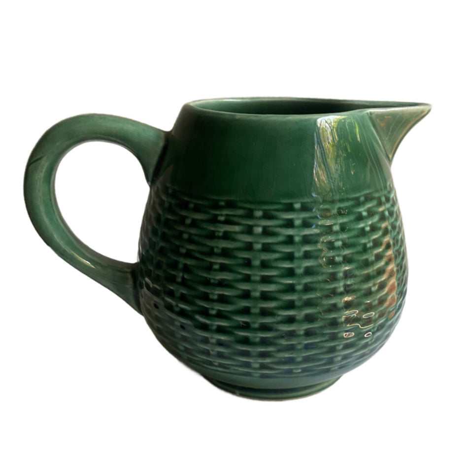 Side view of antique French green basketweave majolica pitcher