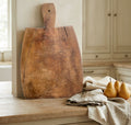 Early 19th century French hand-carved wooden cutting board with dark patina and short handle