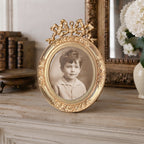 Antique French gilt photo frame with rare bow details Louis XV Dore bronze  on a French country mantel with books and white hydrangeas