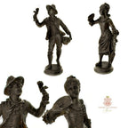 Side and face view of antique French sculptures, he holding a cherub figure, se holds a fan.