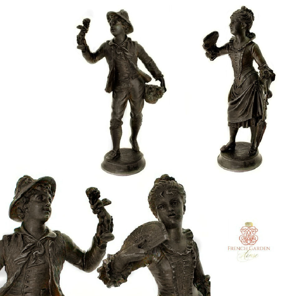 Side and face view of antique French sculptures, he holding a cherub figure, se holds a fan.