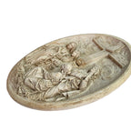 Side view showing depth and sculptural detail of plaster religious wall plaque
