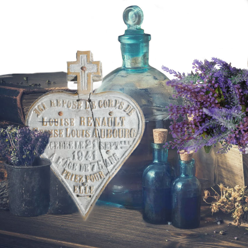 Antique religious plaque displayed with aqua glass and lavender and antique books