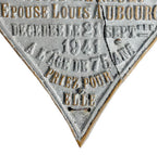 Close detail of raised lettering in memoriam Louise Renault