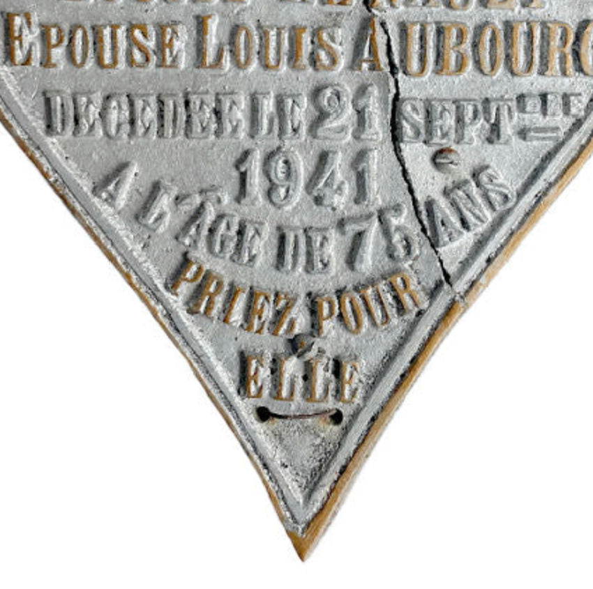 Close detail of raised lettering in memoriam Louise Renault