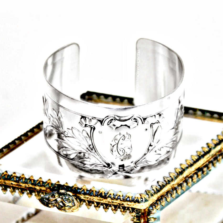 Antique French sterling silver cuff bracelet featuring an engraved heraldic shield and foliate design. Elegant, rare, and timeless.