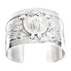 Antique French sterling silver cuff bracelet featuring an engraved heraldic shield and foliate design. Elegant, rare, and timeless.