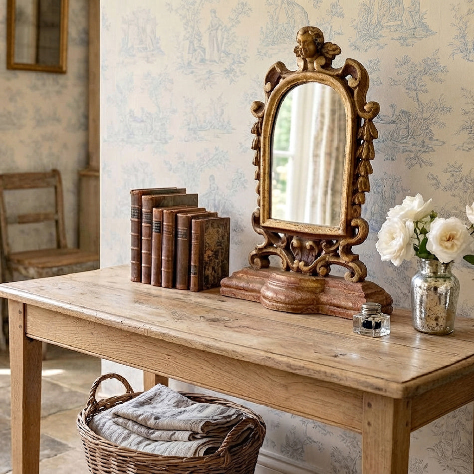 Elegant antique carved wood mirror with cherubs styled in soft French country décor