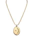 Antique crescent moon locket with nine paste stones and etched starburst