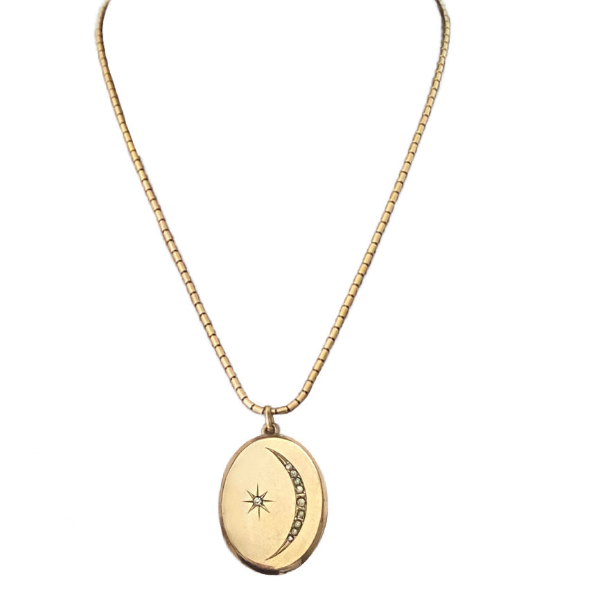 Antique crescent moon locket with nine paste stones and etched starburst