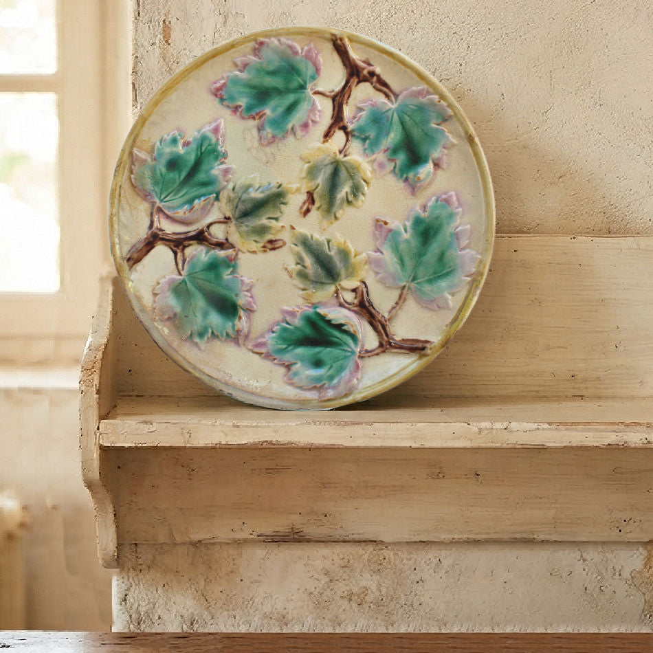 Antique Griffin Smith & Hill Majolica maple leaf plate displayed on a French Country shelf