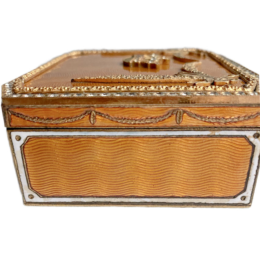 Side view showing guilloché enamel and gilt-metal decoration