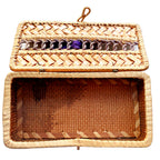 Antique shellwork box with original purple silk ribbon, showing its aged inside condition