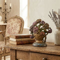 Antique floral urn doorstop styled on a french country table in France