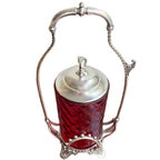 Antique Victorian silver plate pickle castor showing twisted wire handle, finial, lid, and side tong hook
