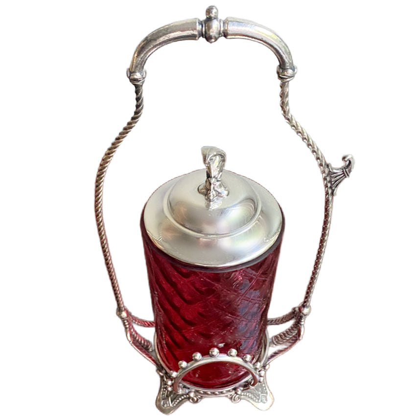 Antique Victorian silver plate pickle castor showing twisted wire handle, finial, lid, and side tong hook