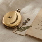 Antique oval gold-filled locket with crescent moon and Victorian paste stones with French letter