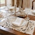 Antique Madeira embroidered linen placemats elegantly styled on an antique French dining table