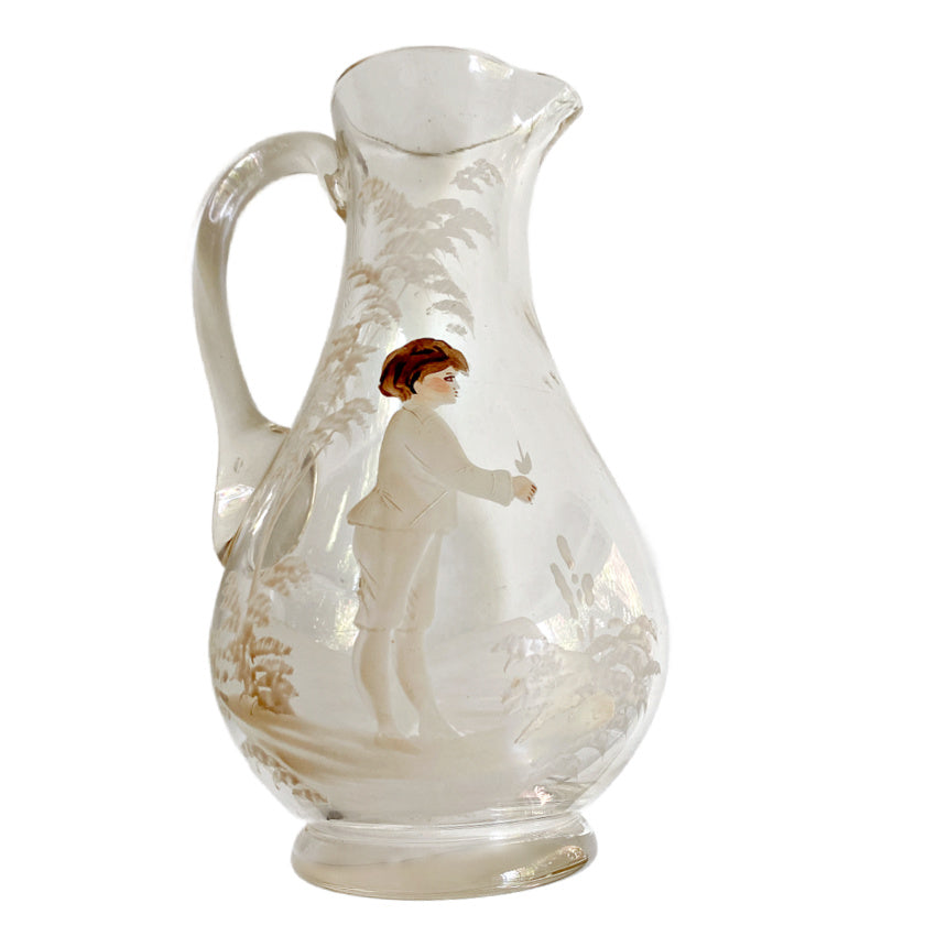 Antique Mary Gregory glass pitcher with hand painted boy and white enamel trees side view