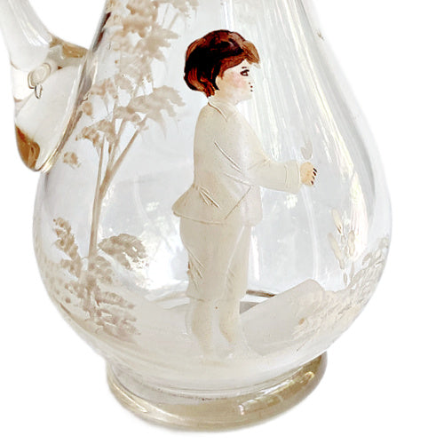 close up of Antique Mary Gregory glass pitcher with hand painted boy and white enamel trees
