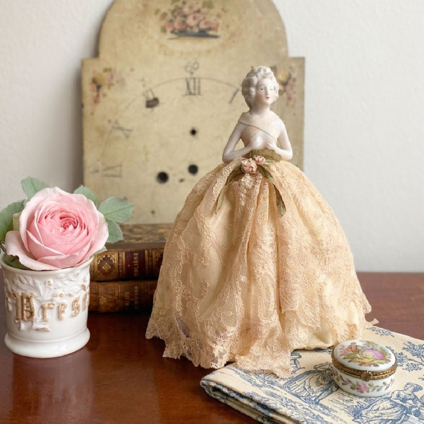 French lace boudoir lighting with café au lait skirt and gold ribbon detail, Marie Antoinette styling with pink roses.