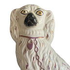 Antique Staffordshire dog figurine with hand-painted decorative accents facial view