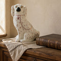19th century English Staffordshire dog with pink lustre collar and chain on antique French Country Commode with antique French linen and leather book