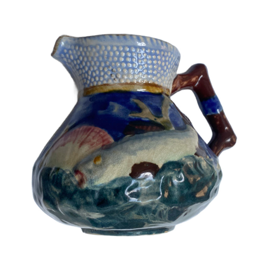 Charming English Majolica pitcher by Shorter & Sons, with raised fish and shell design in ocean hues—Staffordshire coastal beauty.
