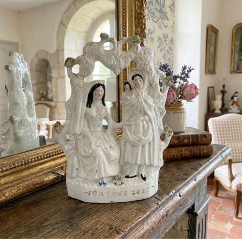 Antique Staffordshire Fortune Teller bower mantel figure in warm French Country home setting