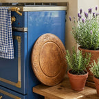 1800's hand carved wooden bread board with soft patina in French country kitchen vignette