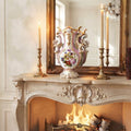Antique Vieux Paris hand-painted pink rose porcelain vase displayed on a French mantel with candles, fire, and mirror