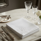 Antique embroidered linen napkins with MWA monogram styled on elegant marble table