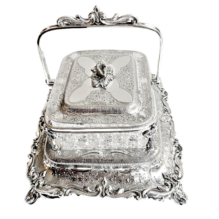 
Ornate antique Mappin & Webb silver-plated sardine server with cut crystal liner and scrolled feet. A rare, collectible English tableware piece.