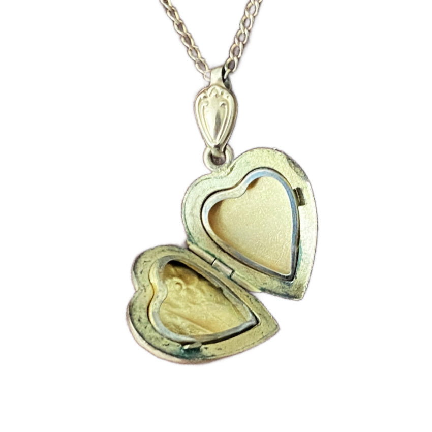 Antique heart locket with elongated shield-shaped bail with original frames