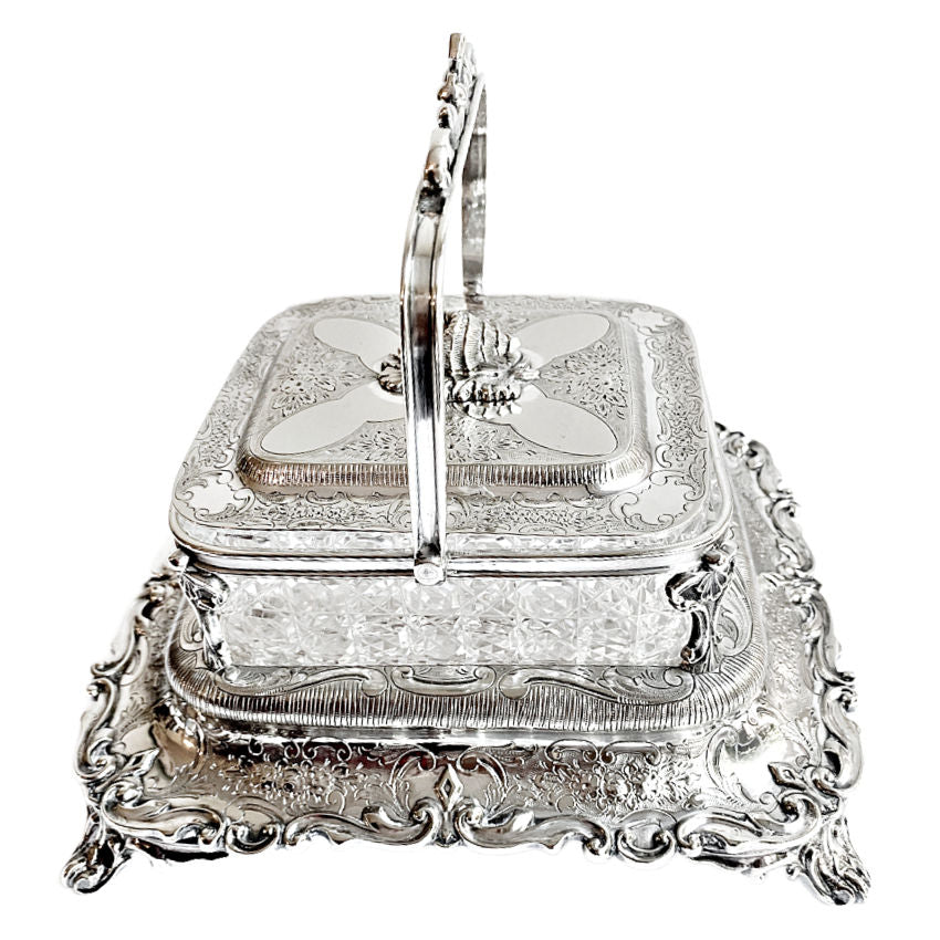 
Ornate antique Mappin & Webb silver-plated sardine server with cut crystal liner and scrolled feet. A rare, collectible English tableware piece.