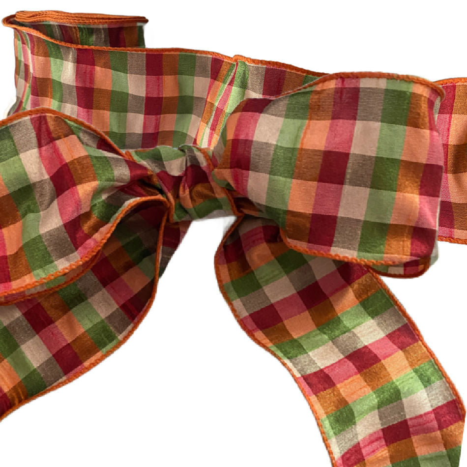 Apple green, orange, beige and red check ribbon used as a gift bow