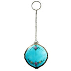A vintage Art Deco compact with Aqua Blue Guilloche and pink roses design, complete with a chain and finger ring.