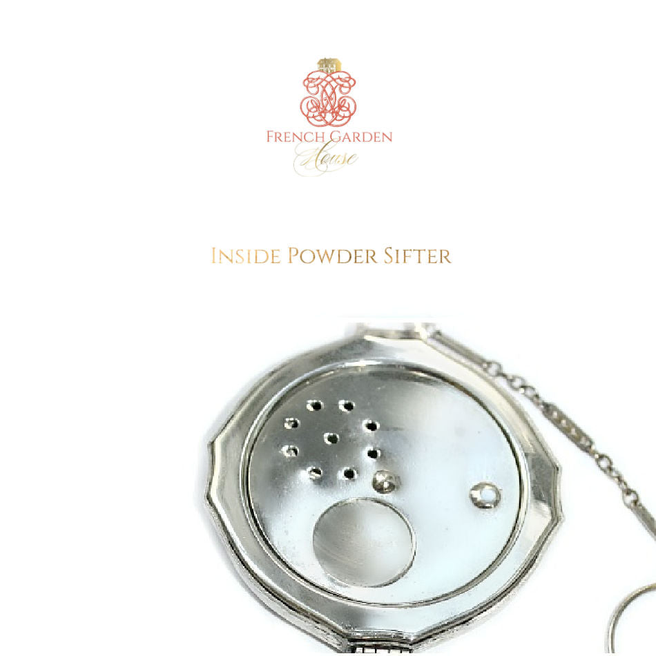Open compact revealing mirror, powder compartment, and original sifter with delicate Art Deco detailing