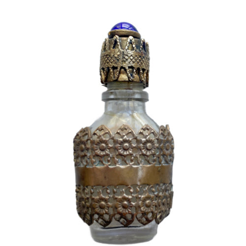 Exquisite Art Deco miniature perfume bottle with sapphire blue glass jewel and ornate gold filigree lid. A rare antique vanity treasure of timeless elegance.