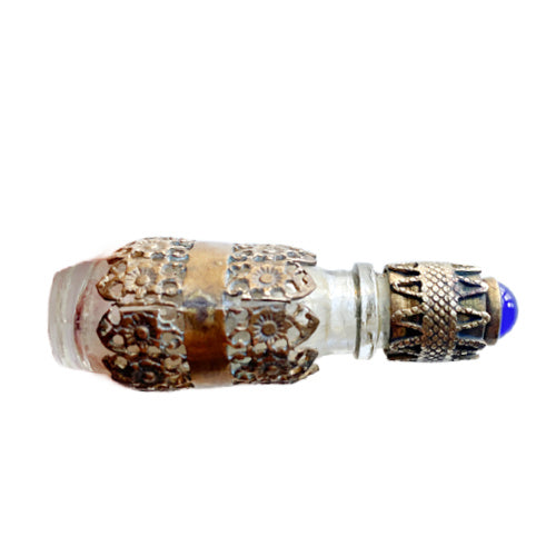 Exquisite Art Deco miniature perfume bottle with sapphire blue glass jewel and ornate gold filigree lid. A rare antique vanity treasure of timeless elegance.