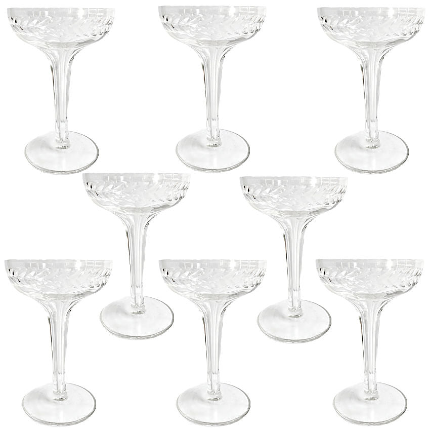 Art Deco hollow stem champagne coupes, set of 8, each with laurel wreath encircling the bowl. Hand-blown 1920s–30s glass, perfect for vintage bar décor.