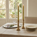 Bamboo beeswax taper candles glowing in elegant home setting with natural texture