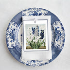 French garden floral gift tags with blue dotted grosgrain ribbon set on a plate as a dinner place card