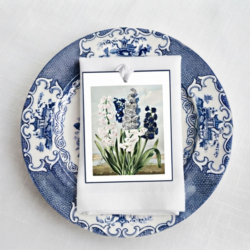 French garden floral gift tags with blue dotted grosgrain ribbon set on a plate as a dinner place card