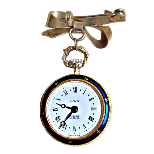 Cobalt blue enamel bow pin watch with Liga movement, a refined decorative jewel for your collection.