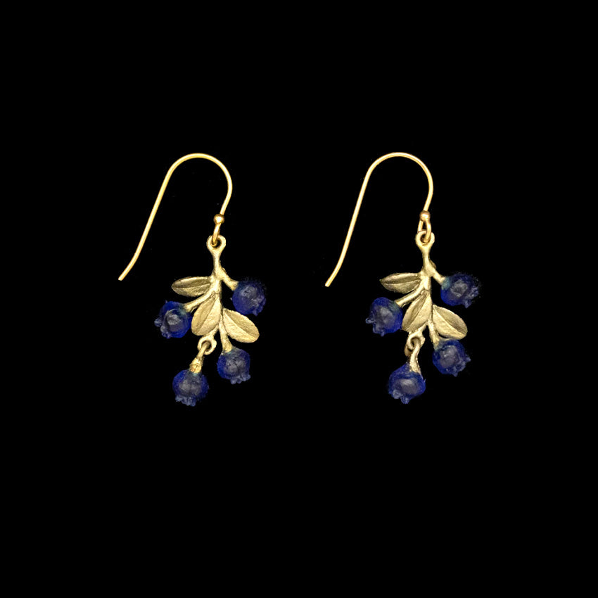 Artisan-made bronze earrings inspired by wild blueberries, featuring green patina leaves and shimmering blue glass berries